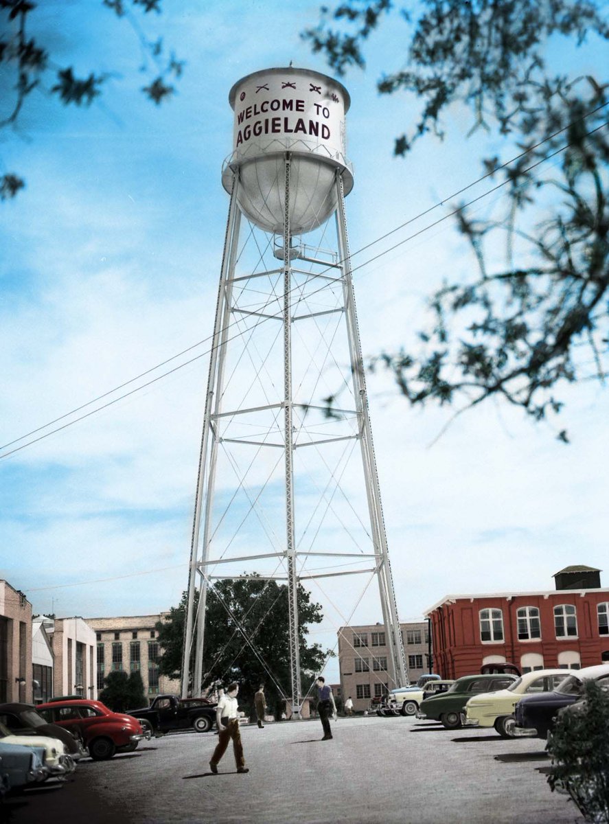colorized photo of metal water tower reading "welcome to aggieland" surrounded by old buildings on campus
