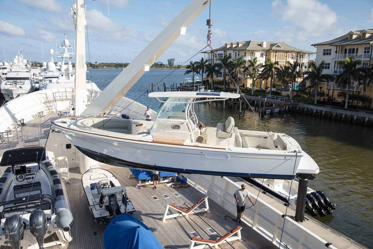 Huntyachts's tweet photo. #TBT Our most recent delivery of a 32cc was the perfect tender to this superyacht. #Tender #Superyacht #Dinghy #DinghyLift #TenderLift #OnDeck #Florida #Yachting #Crew #YachtDelivery #CenterConsole #HuntYachts #32CC #HuntCC https://t.co/JWLKbQnZlE