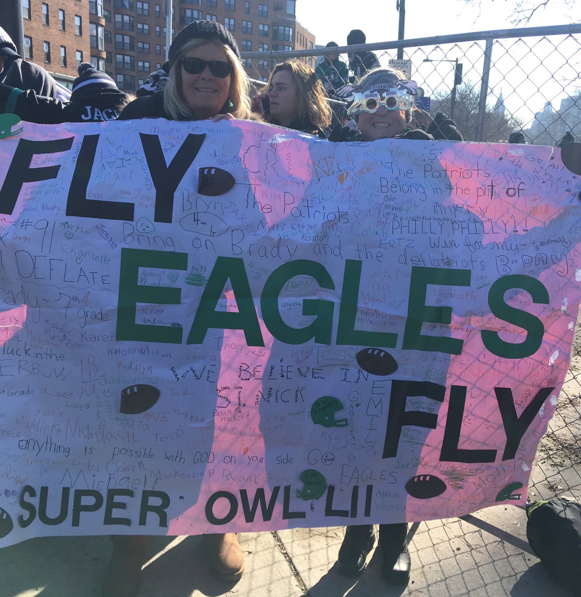 qoa_school's tweet photo. Mrs. Brown and @PatVenafra took QOA's student messages to the parade for the @Eagles today!  This banner, made by Mrs. Brown, hung in our gym and was filed with messages of congratulations and encouragement from our students!  #FlyEaglesFly @ArchPhilly @aoptech @CatholicPhilly https://t.co/hoX8WEiobc