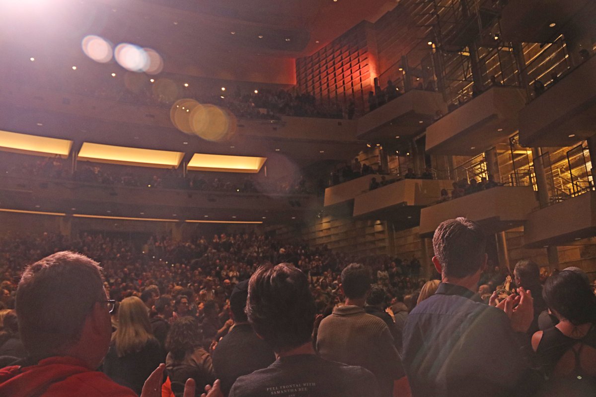 PodSaveAmerica's tweet photo. Tonight in Denver, a Dreamer stood up and admitted during the Q&amp;A that this was the first time in her life that she was afraid of getting deported. 2,800 stood to applaud her. Her q: "How do we flip Utah-04?"

Every vote counts: https://t.co/WejMkK75TR https://t.co/JXvvM9Fqva