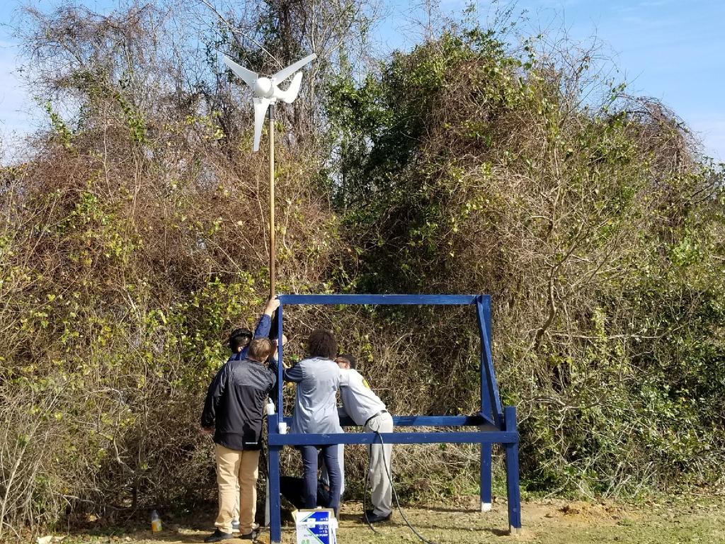 MPCTE Aquaculture students raise their wind-powered turbine that will help power their bio-filter.