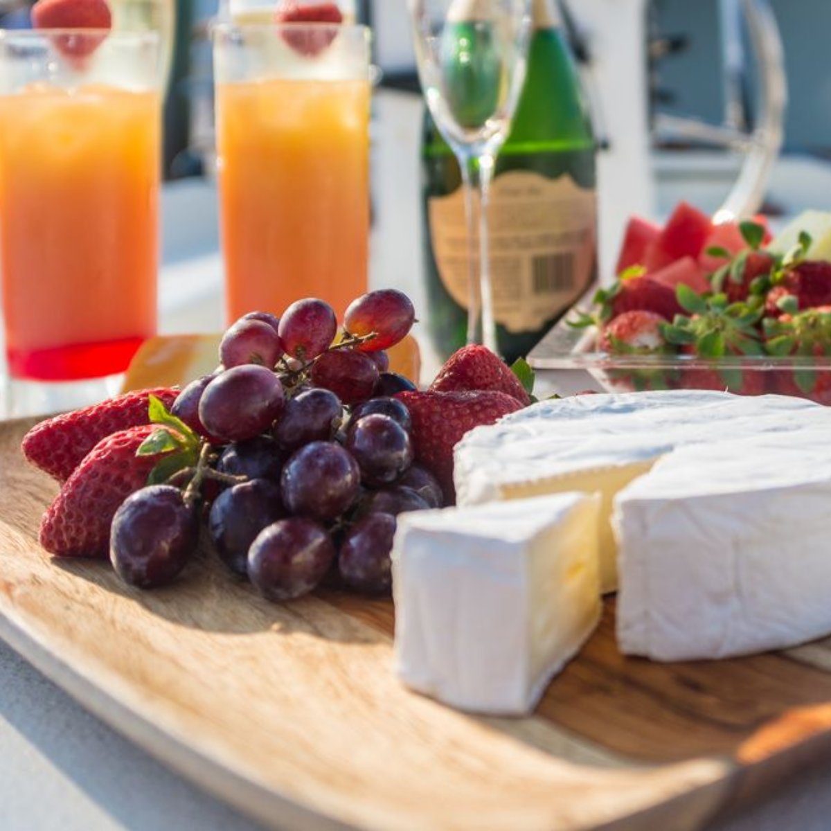 Add an upgrade to your private charter with our gourmet cheese board and tropical drinks.