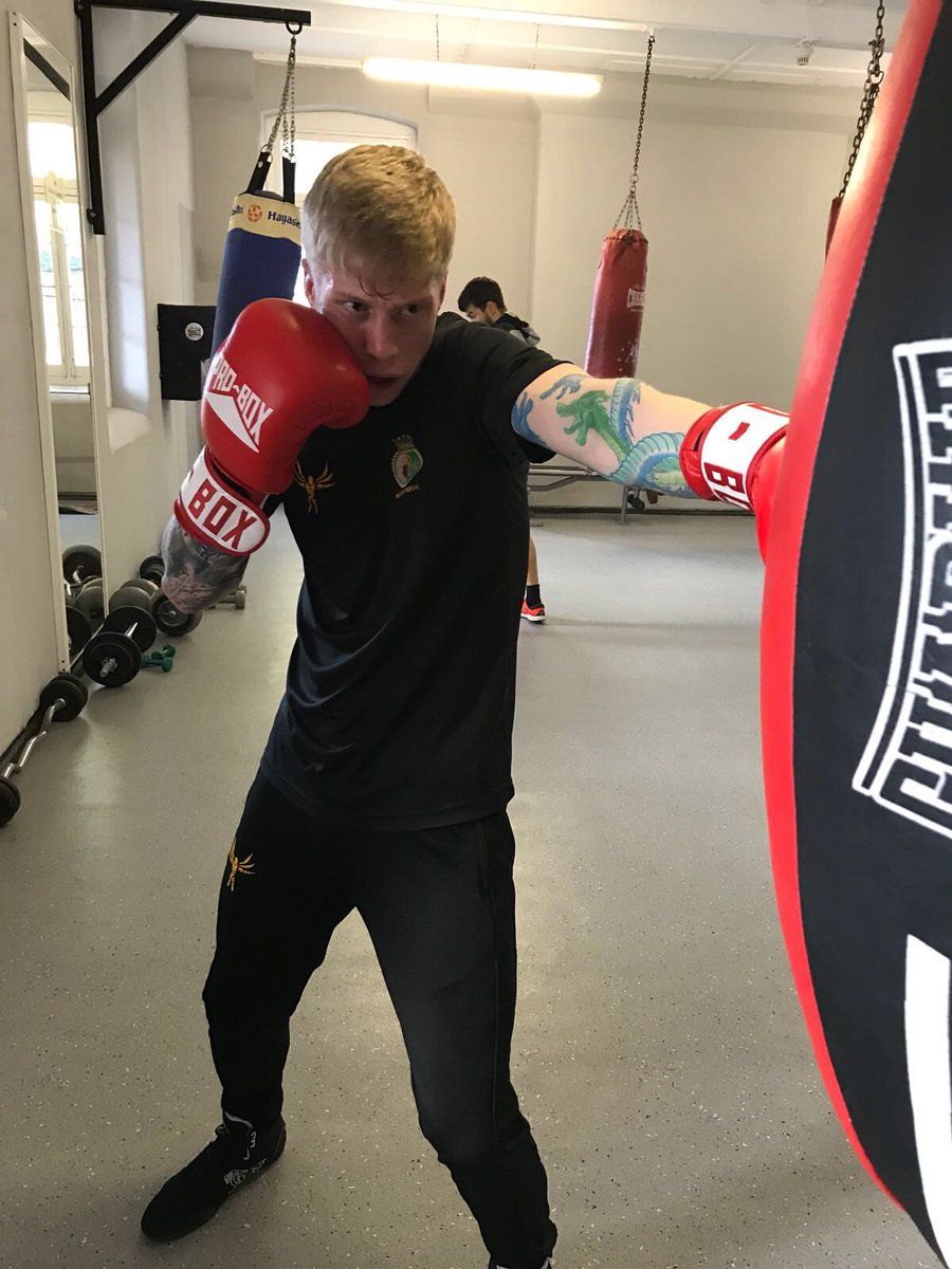 Boxer punches punch bag.