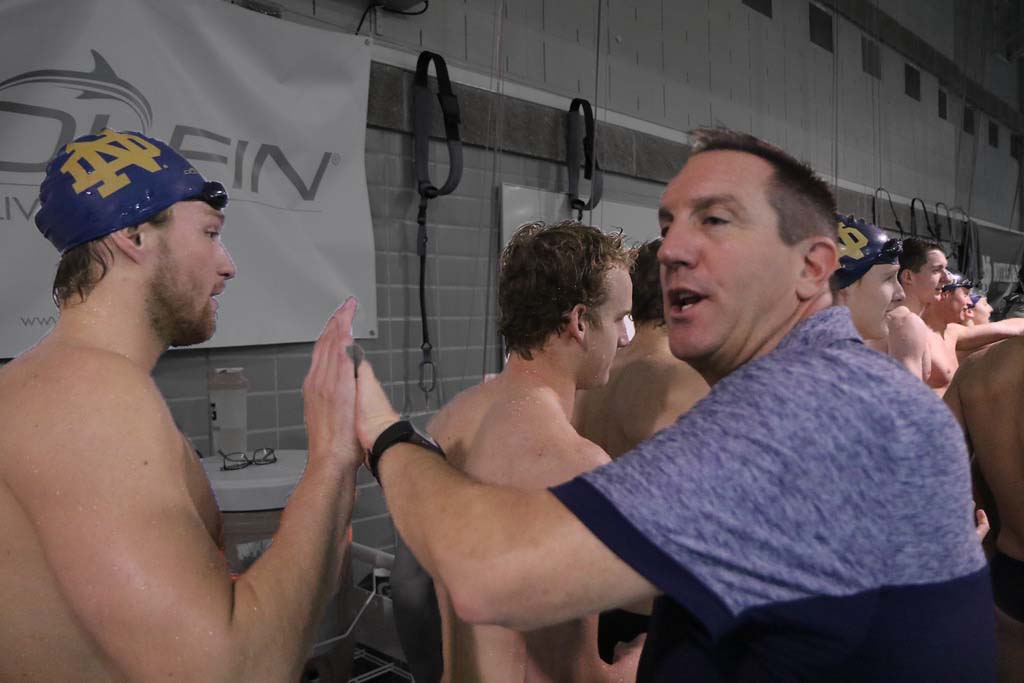 SwimmingWorld's tweet photo. Irish Rising: Notre Dame Swimming Setting Bedrock Under Mike Litzinger https://t.co/pI2dHD5P34 @NDSwimDive https://t.co/8pyuXBycMU
