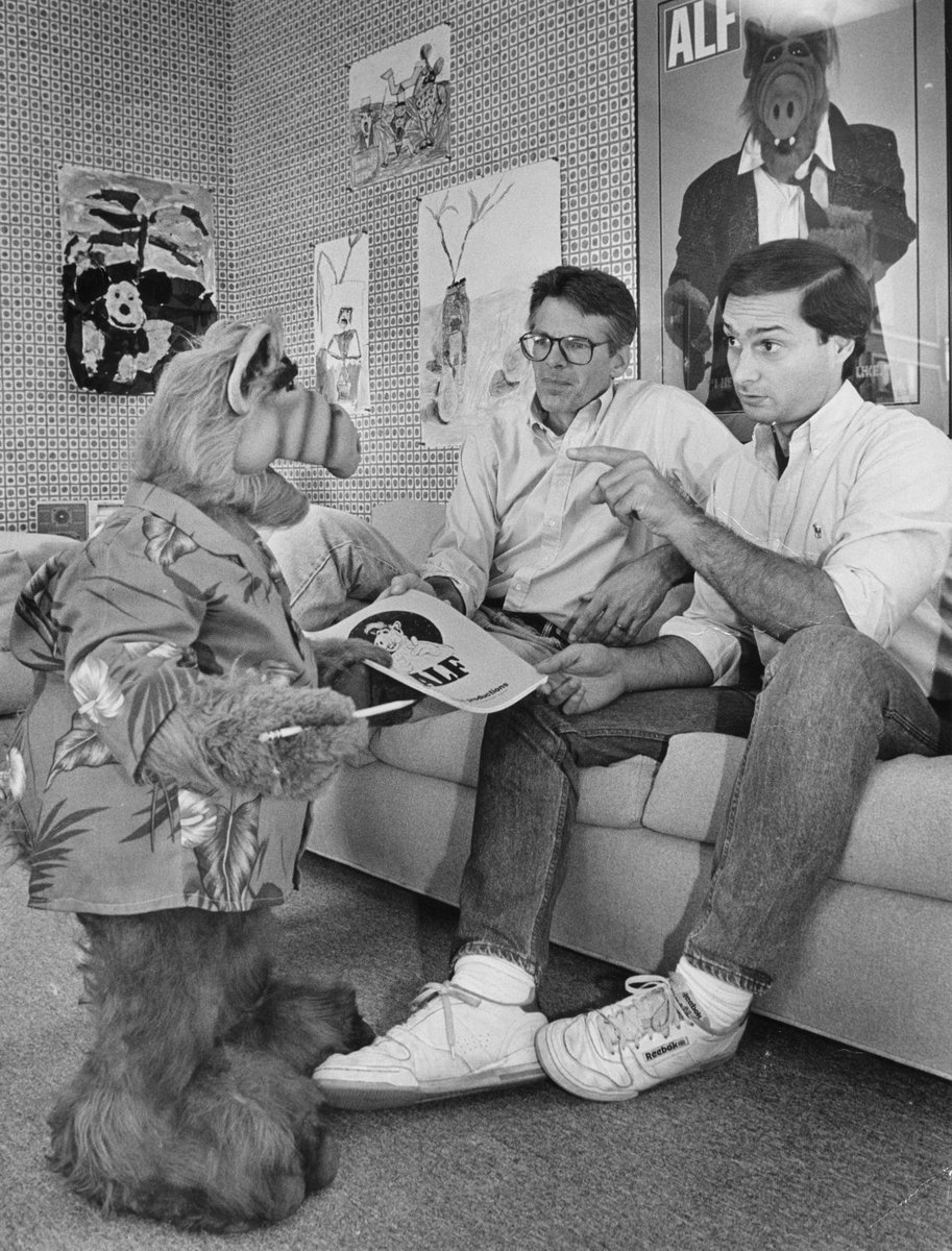 Writer and co-creator Tom Patchett, left, and voice actor Paul Fusco, right, voice are confronted with last-minute script changes from star ALF. Herald Examiner Collection, 1987