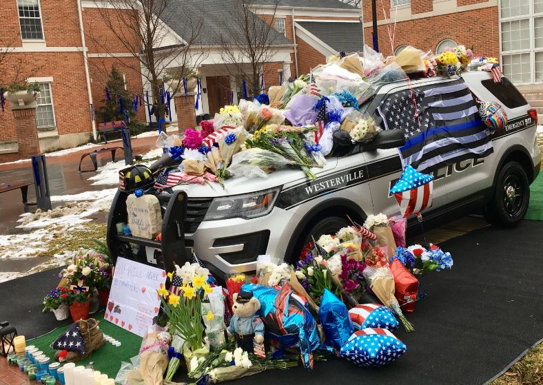 10TV's tweet photo. Westerville Police cruiser covered with flowers and balloons following the tragic death of 2 police officers https://t.co/PXM9HEc1Kh #10TV https://t.co/gVjLZlEFXa