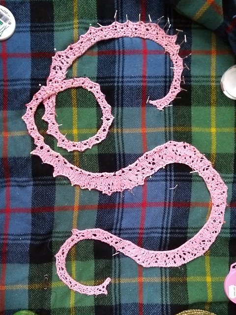 Heroically long pink coil of lace, widening and tapering like some kind of dancing earthworm
