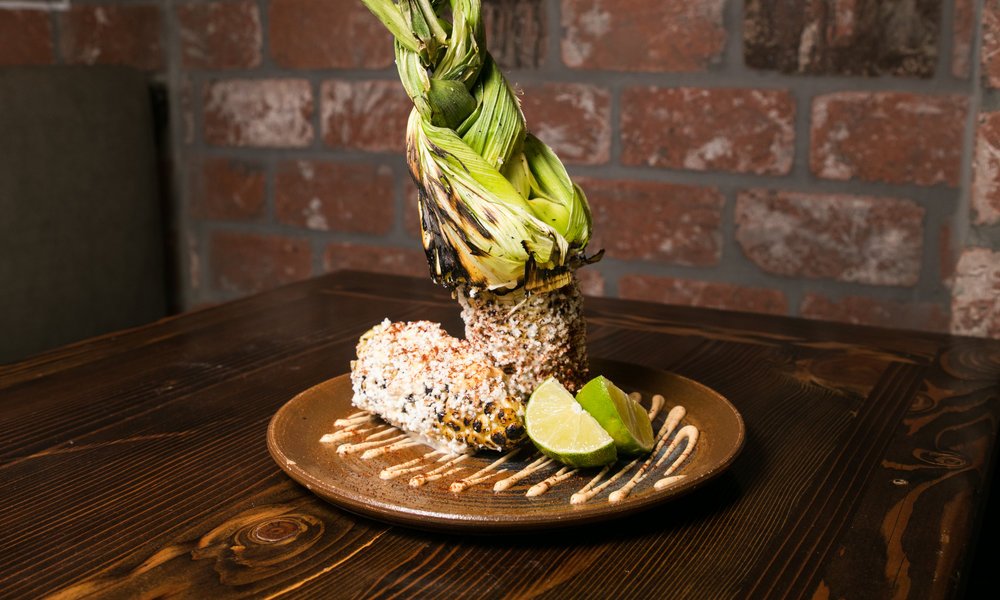 Our Elote (fire roasted whole corn on the cob) is an excellent choice to help warm up on these chilly evenings. #lunamex #sanjose #mexicanfood #elote