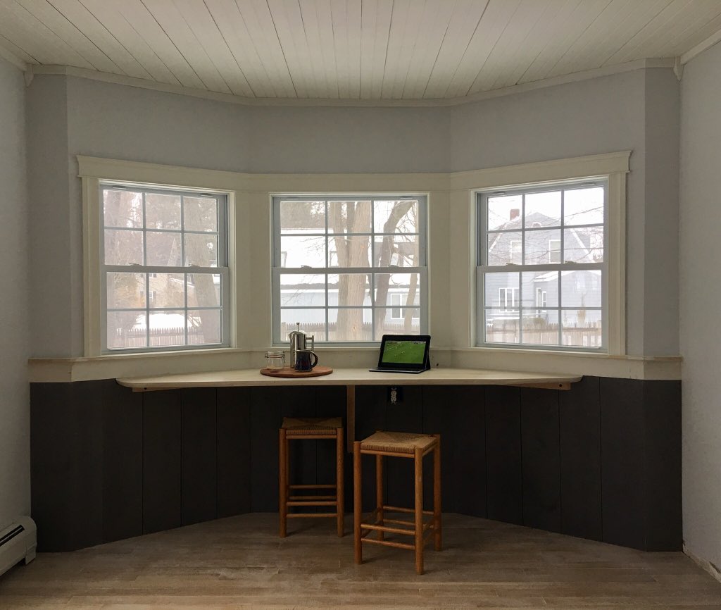 ABCraftsman's tweet photo. Dismantaled an old built in cabinet under the three windows that was well past its prime.  Replaced the old maple floor with a quarter sawn white oak that is white washed. Added some grey washed Pine Wainscoting along with a live edge Oak top! https://t.co/T3d1y7EszA