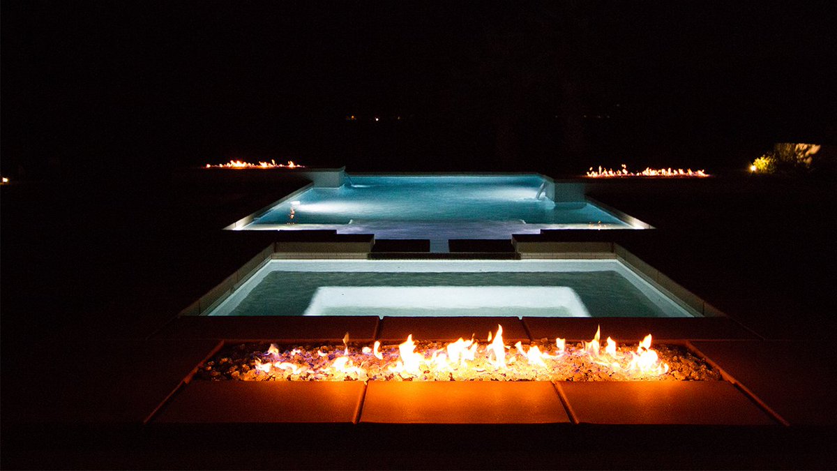 Fire pits with glass beads add color, texture, and lighting to these sleek geometric pools.