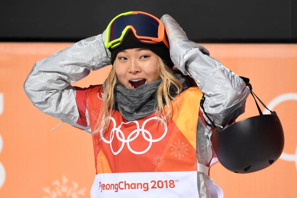 snowboarder Chloe Kim puts hands on head in excitement after winning gold