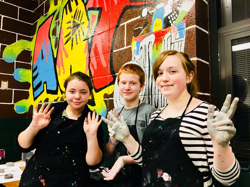 A huge part of the school culture @NEMS_STEAM centers around the arts, as students learn and express their creativity through visual arts, music and drama. Open House visitors are creating pottery and using printmaking techniques to fashion a Wolverine relief! #MiddleMatters