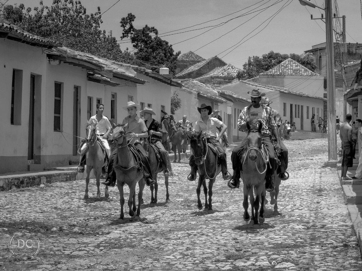 This image taken in Trinidad, Cuba back in 2010. Walking the cobblestone and dirt roads of Trinidad felt like walking through another period of time. This is a group of friends headed to the town square where townspeople socialized and showed off their latest horse riding tricks.