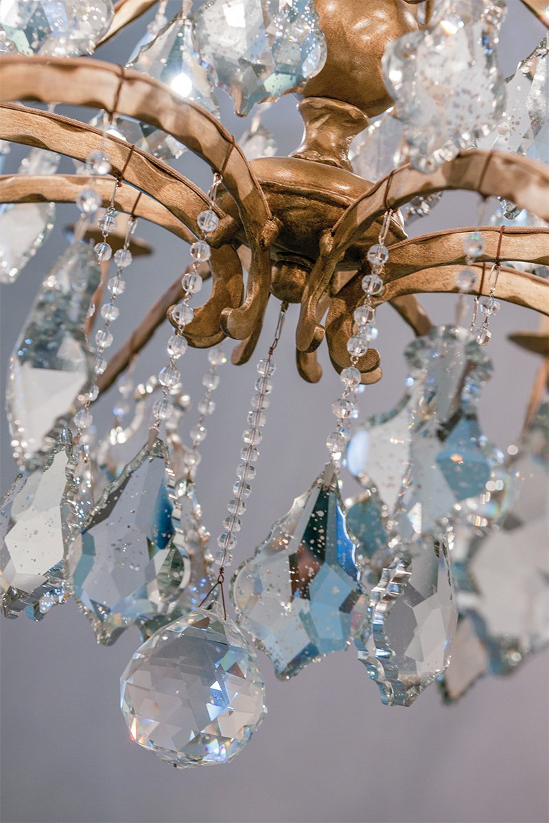 Troy Lighting's Sienna chandelier — antique mirrored crystal with hand-worked iron and cast aluminum sets the standard, while the Vienna Bronze finish leaves Sienna awe-inspiring.
