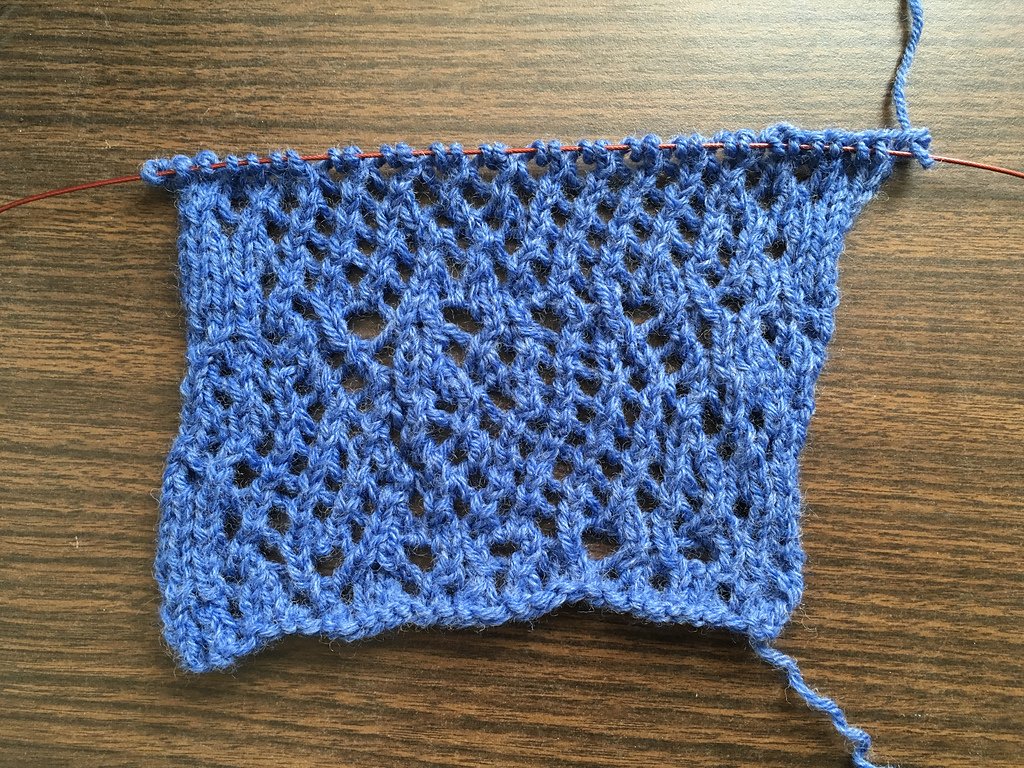 Knitted swatch. An uneven open lace.