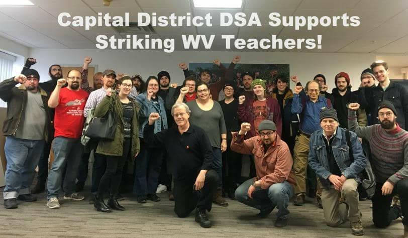 ~25 Capital District DSA members, fists raised