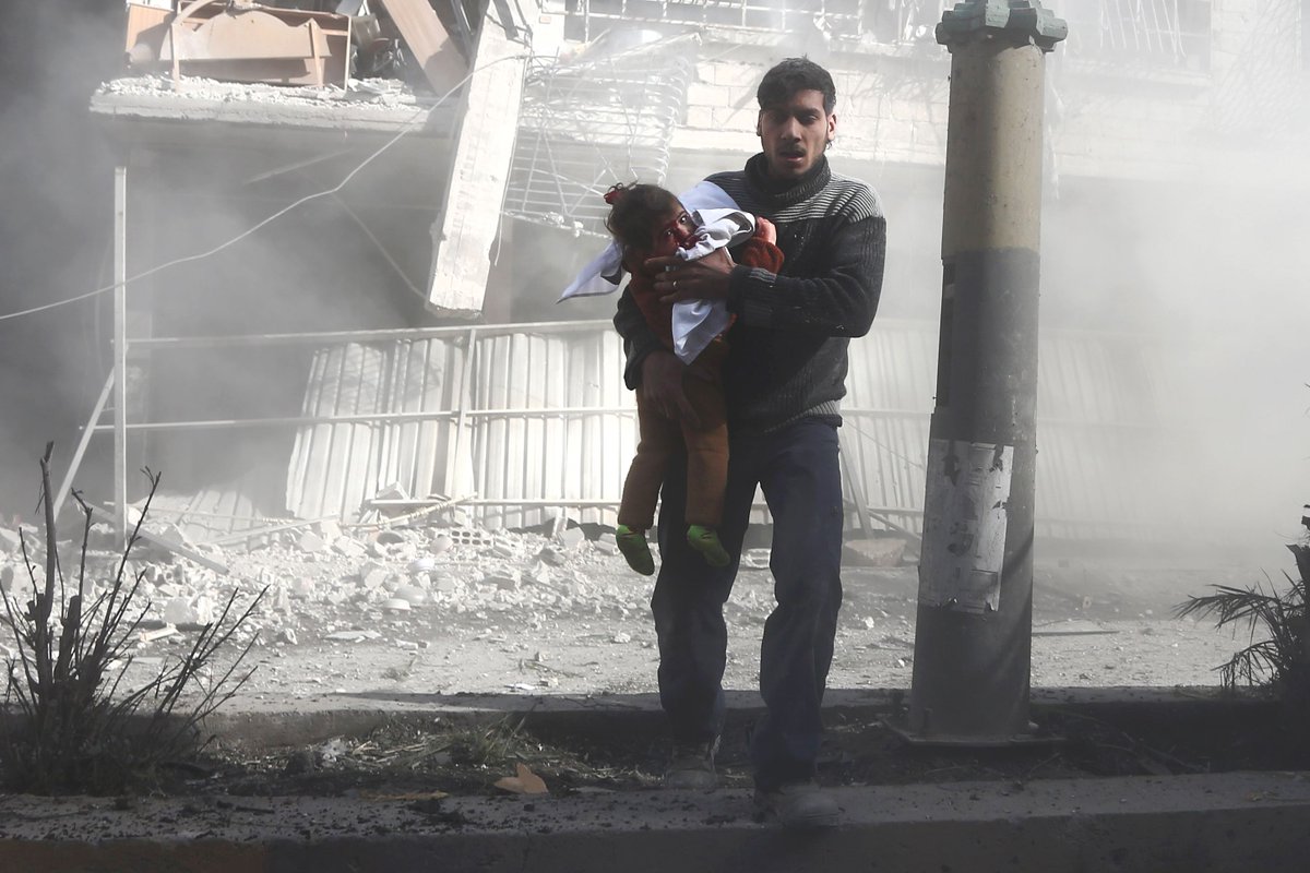 A tactical war between USA & Russia has taken lives of more than ten thousand innocent children. A Syrian man carries a girl injured in government bombing in  town of Hamouria, in the besieged Eastern Ghouta region on February 19. My twitter friend pls open ur mind.