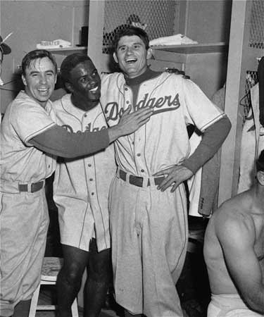 baseballinpix's tweet photo. Pee Wee Reese, Jackie Robinson, and Preacher Roe celebrate in the locker room after a win in the 1952 World Series https://t.co/qmLzpzyYUr