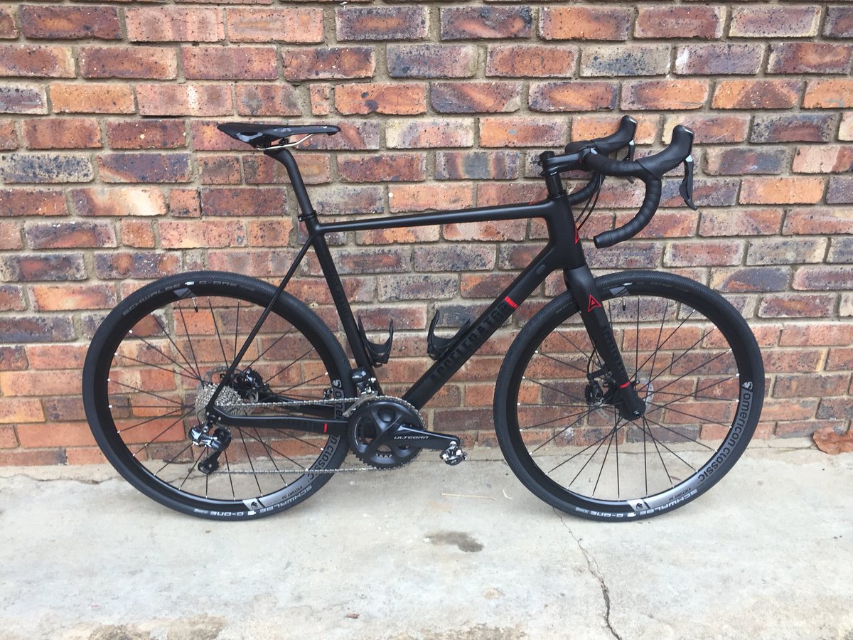 CustomzdCycling's tweet photo. Bruce’s #NewBike @AcceleratorBike #SuperClean #Concept-Gravel #MattBlack &amp; #GlossBlack @ShimanoROAD #Di2 @SchwalbeZA  @fizikofficial @Elite_cycling 

#Stealth #cxworlds #GravelBike #Electronic #SuperFast #Comfortable #Carbon #BlackOnBlack #DiscBrake https://t.co/0k2Ks5w5Gx