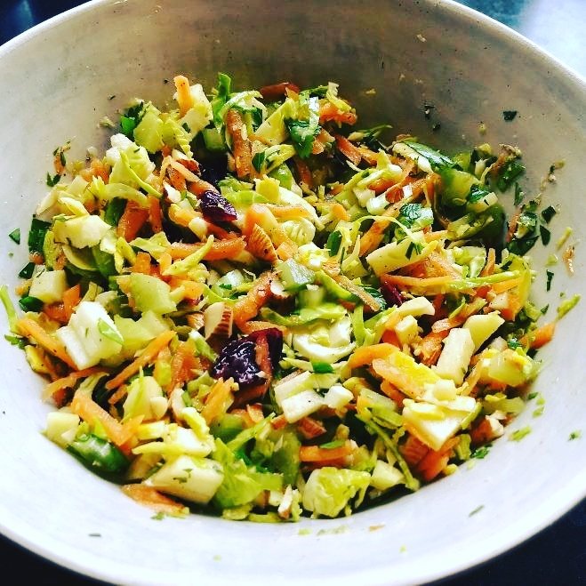 Sprouts slaw-style.  Raw, shredded with carrots, celery, apple, blanched almonds and parsley, dressed with pomegranate molasses and tangerine juice.