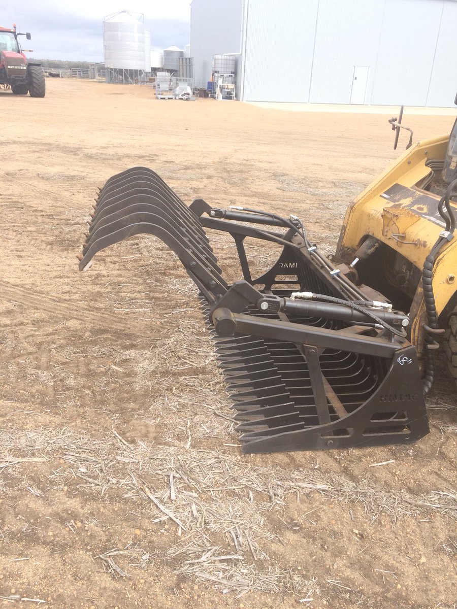 Custom made grapple for the rock bucket to sweep/grab rocks and roots