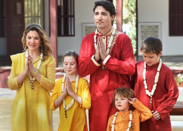 Canadian Prime Minister Justin Trudeau in a red kurta and garland, accompanied by his family on a visit to India.