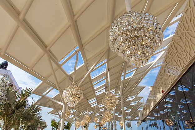 EventchicD's tweet photo. 30 crystal chandeliers swayed in the gentle breeze which drifted across the tensile structure of the Burj Al Arab Terrace. This was the first time something of this magnitude was allowed to be suspended off the ceiling and it truly set a benchmark. https://t.co/cjy5wm1hJX