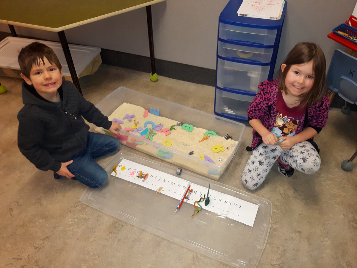 This is what play-based learning is about.  Two of our Kindergarten students having fun while practicing the alphabet.