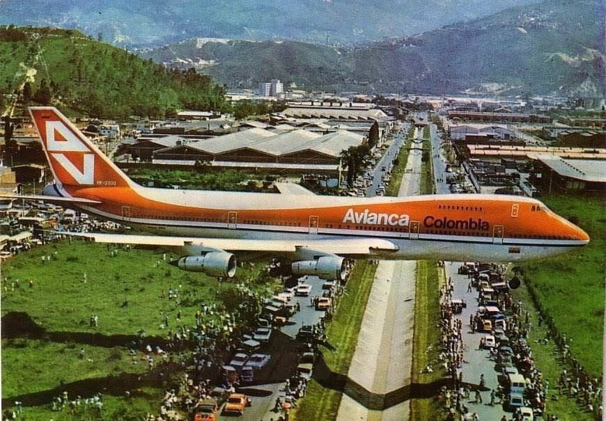 People gather to watch the first ever Boeing 747 to land in the small airport of the city of Medellin Colombia (1976).