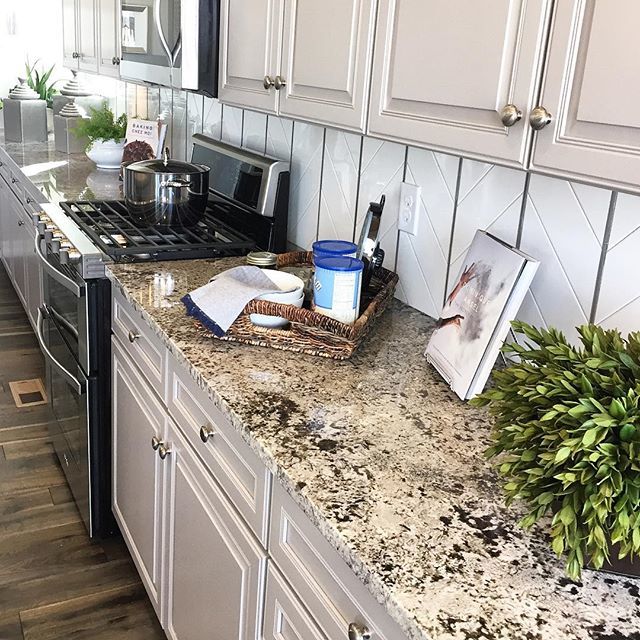 Almond toned cabinets with cooler tones - a slight adjustment from the stark white cabinets we've witnessed over the past few years. Do you like this look? #kitchenremodel #kitchendesign #paintedcabinets #gourmetkitchen #lovecoloradoliving #homedecor #re… ift.tt/2HIhDj6