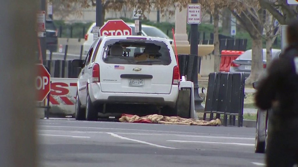 Left wing nut job ploughs vehicle into security barrier