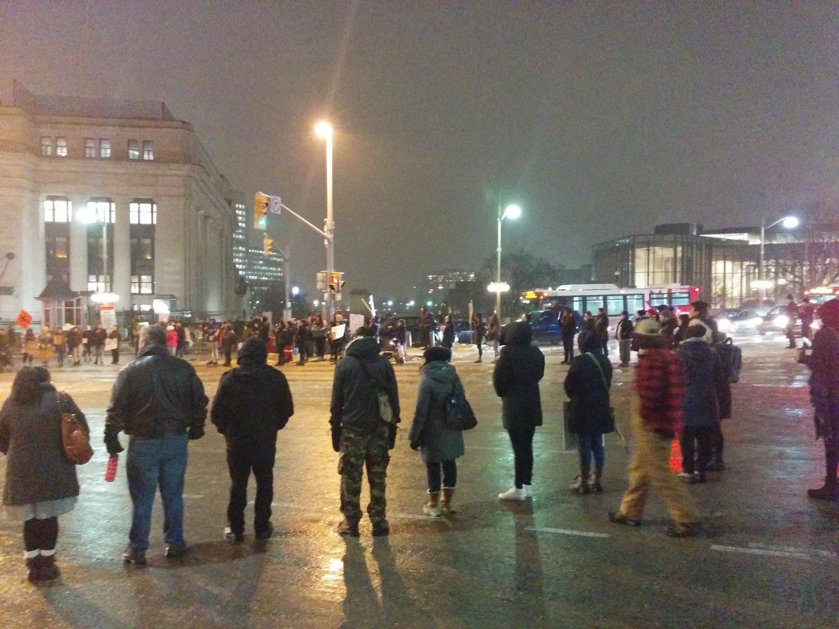 Appears to be a protest of about 100 people here in Ottawa at Mackenzie and Wellington. Protesters lined across the streets blocking intersection. Seeing signs of #NoMoreMMIWG #NoMoreMMIMB #JusticeforTinaFontaine #cdnpoli