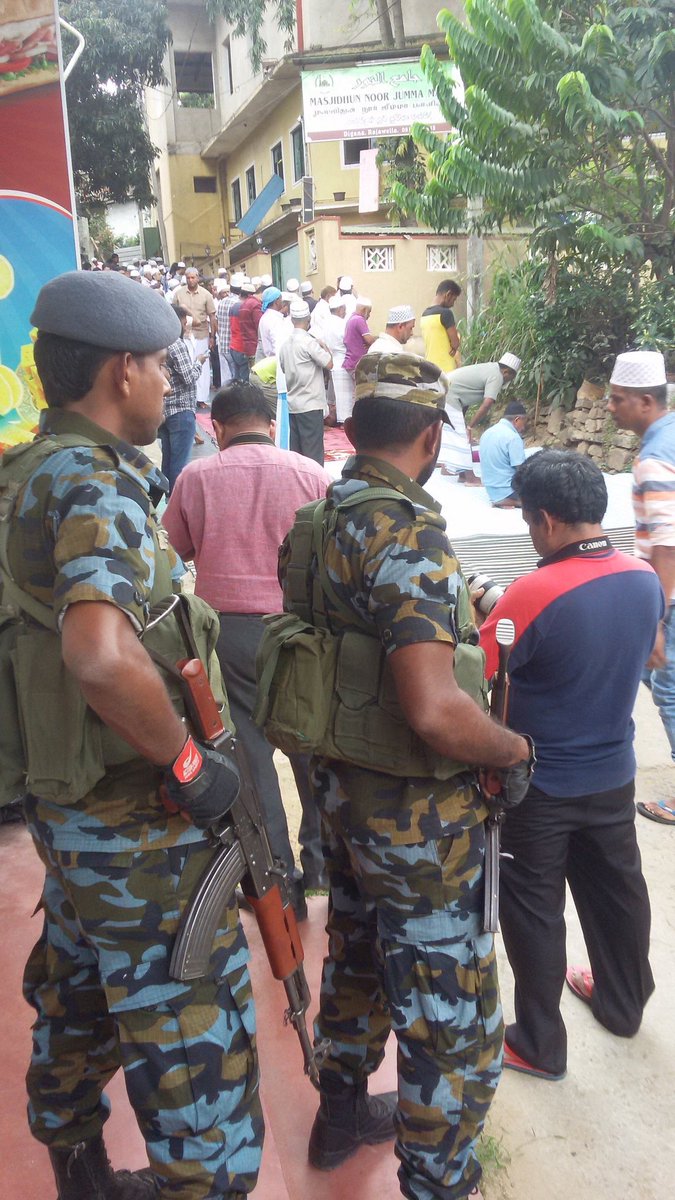 razanahmedd's tweet photo. #Digana #lka prayers on the road. Outside the Mosque unusable after destruction. Under armed military protection from both ends https://t.co/FJZhLViLtp