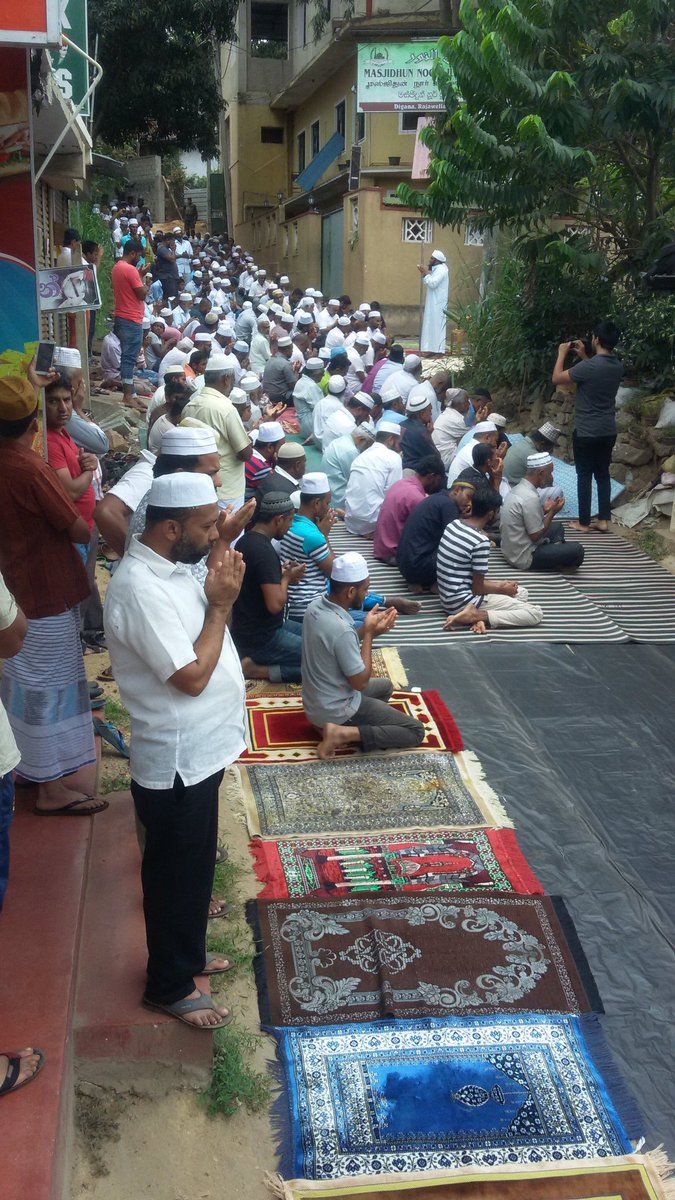 razanahmedd's tweet photo. #Digana #lka prayers on the road. Outside the Mosque unusable after destruction. Under armed military protection from both ends https://t.co/FJZhLViLtp