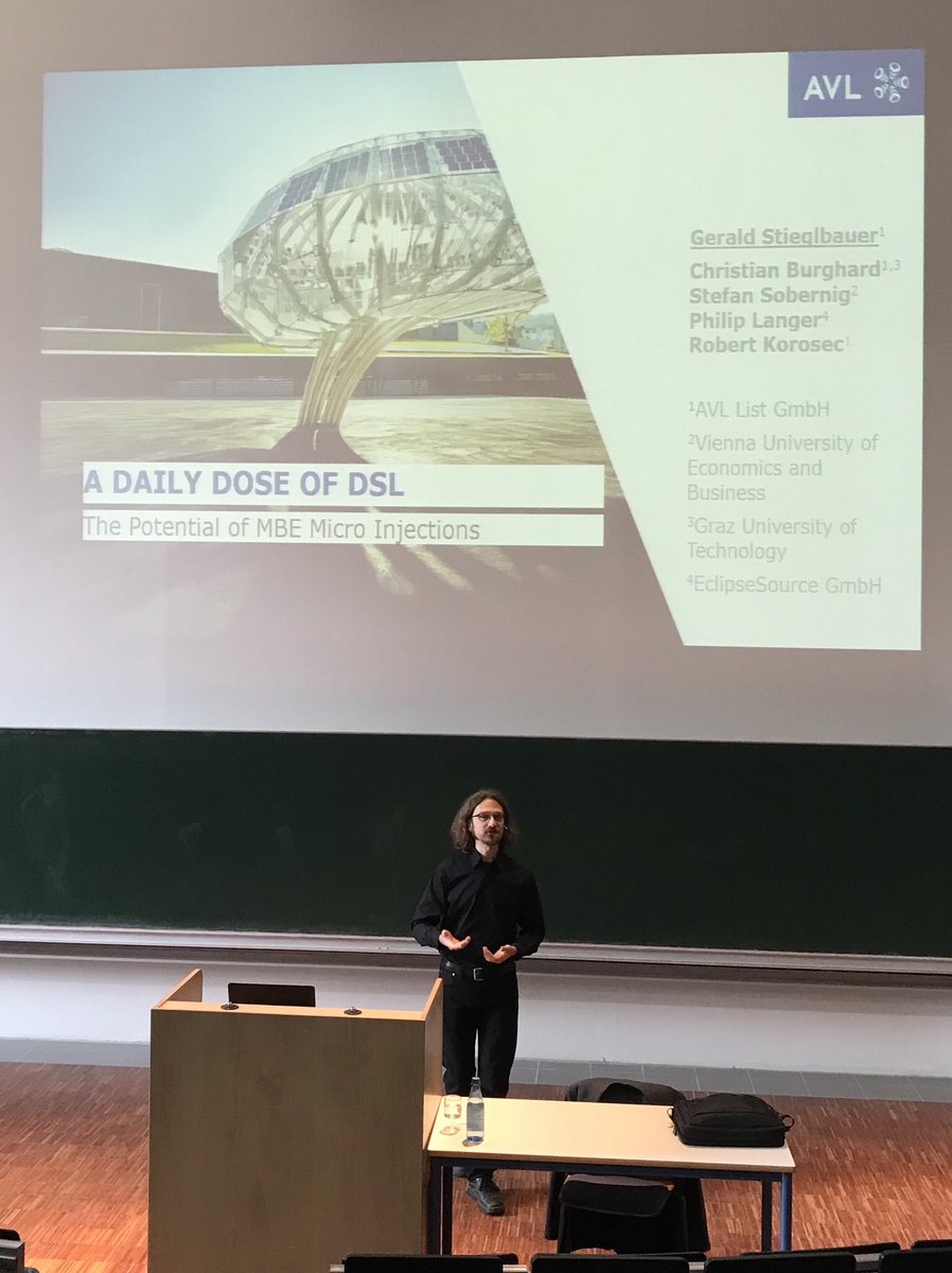 stsauer13's tweet photo. „A daily dose of #DSL“ - Keynote-Vortrag über das Potenzial von #MBE #MicroInjections von Gerald Stieglbauer, Techno-Scout bei der #AVL List GmbH, einem führenden Entwickler von Testständen für Fahrzeuge. #Modelle &amp; MBE zur Beherrschung der Komplexität. #SESWM18 #SE18 @SESWM18 https://t.co/bM2djgZIoc