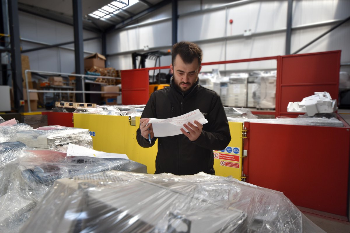 Export Manager Ashley McCall doing his final checks before releasing this mornings shipment of used copiers, bound for the other side of the globe.