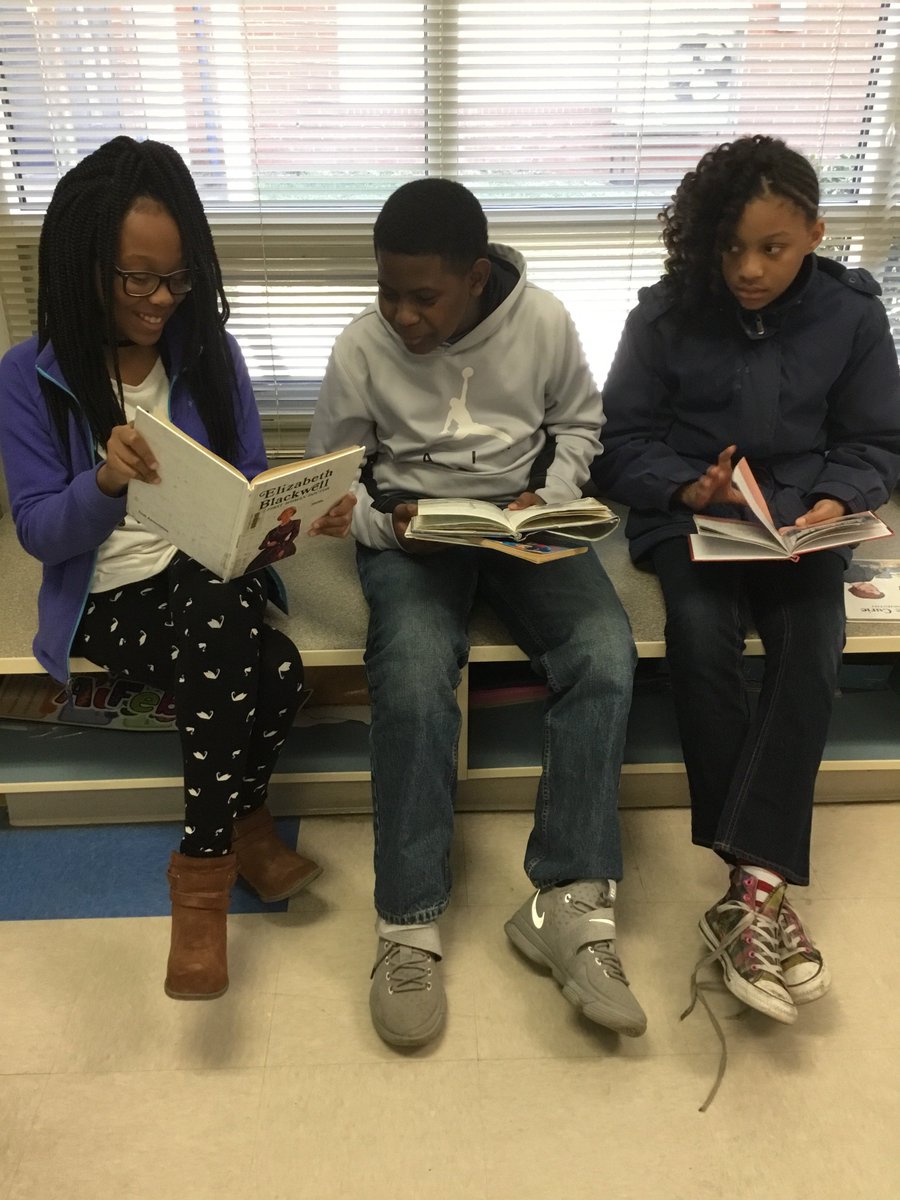 Martin_Martians's tweet photo. Students in Block 2 are using book stations to help pick a woman they will research for their #womenshistory digital project. This student was excited to show me about a female drag car racer. "She likes racing like you, Mrs. M". #Martin_Martians #BanksBest https://t.co/1IFmoM4vf2