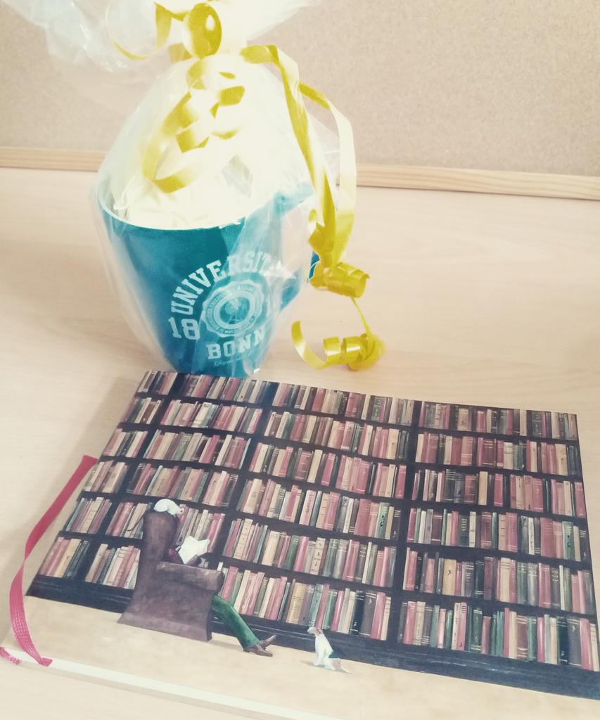 Coni777's tweet photo. Today I said goodbye to my colleagues at Uni Bonn and they had this for me. A survival kit: a cup filled with chocolates and a pen, and a blank notebook with a sweet message inside. Pretty much all I want from life <3 #goodbyeandthanksforallthefish #unibonn #womeninmaths https://t.co/FrnwZLUnB6