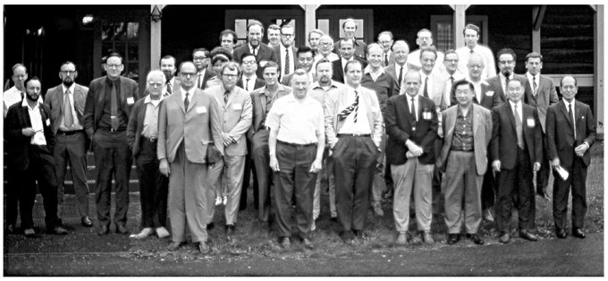 An unnamed woman, mostly hidden, among a group of men at a 1971 International Conference on the Biology of Whales, Skyland.