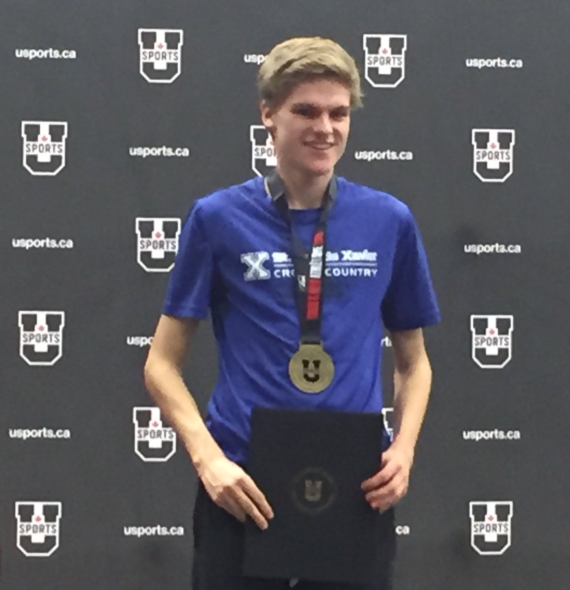 StFXAthletics's tweet photo. Angus Rawling receives his U SPORTS gold medal for the 3000m race! Proud of our national champion! https://t.co/FTulEBdEQR