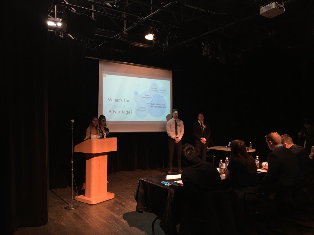 SFUSMA's tweet photo. First team out of our three finalists to present is Supreme Consulting. Their main focus is on millennials and offering free products with purchases. @PepsiCo #SMACKDOWN2018 https://t.co/R3s99LLRn6