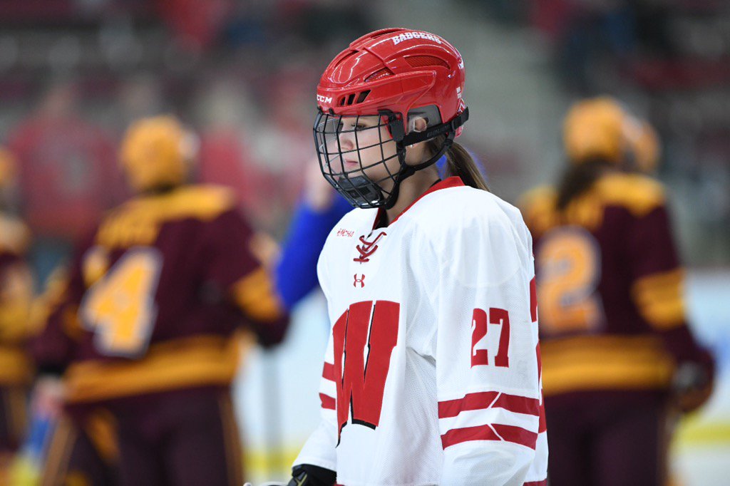 In the background, Gophers warming up to take on <a href="/BadgerWHockey/">Wisconsin Hockey</a> in Madison