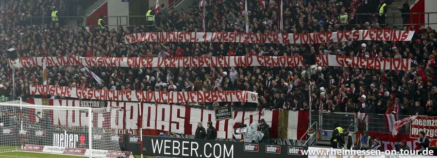 A banner by Mainz fans that says: "Family man, first CEO, club pioneer. Eugen Salomon: The face of a displaced, murdered generation. Process Jewish History!"