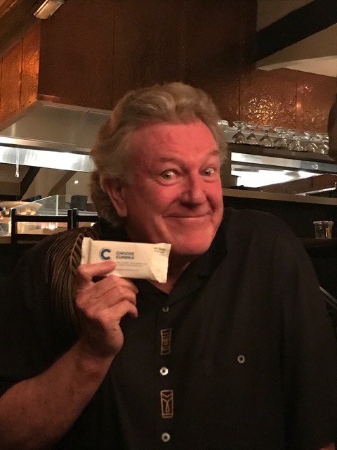 ChooseCumbria's tweet photo. His face says it all! From Cumbria to California: Jeff Keane enjoys our #Kendalmintcake at cartoonists gathering in New Port Beach. Thanks @comicartfest for helping us spread the love all the way to Southern California! #JeffKeane @dottedlines #LICAF #ChooseCumbria https://t.co/k9rGQb186x