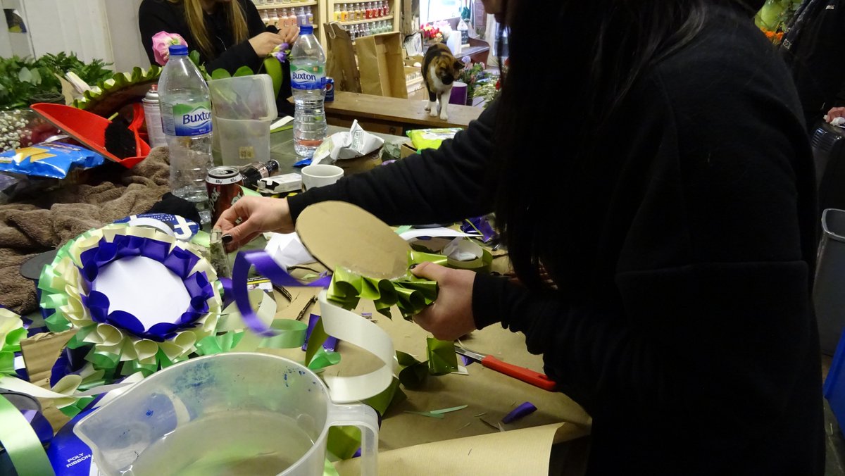 hackneycouncil's tweet photo. Jo's Florist Shop A G Price are making rosettes of differing sizes in the suffragette colours of purple, green and white, ready for Saturday's @WellStMarket women's takeover day! #Votes100 #hackneywomen https://t.co/VB3HDXlv37 https://t.co/KXtfm4zGSK