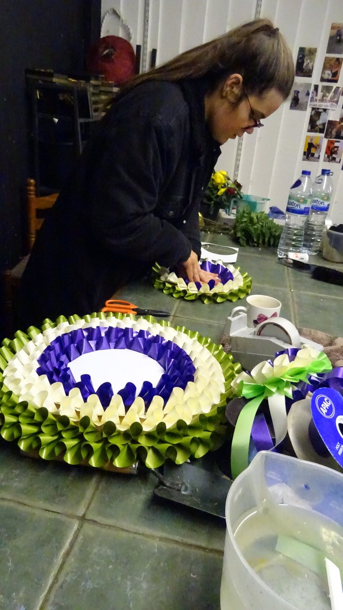 hackneycouncil's tweet photo. Jo's Florist Shop A G Price are making rosettes of differing sizes in the suffragette colours of purple, green and white, ready for Saturday's @WellStMarket women's takeover day! #Votes100 #hackneywomen https://t.co/VB3HDXlv37 https://t.co/KXtfm4zGSK