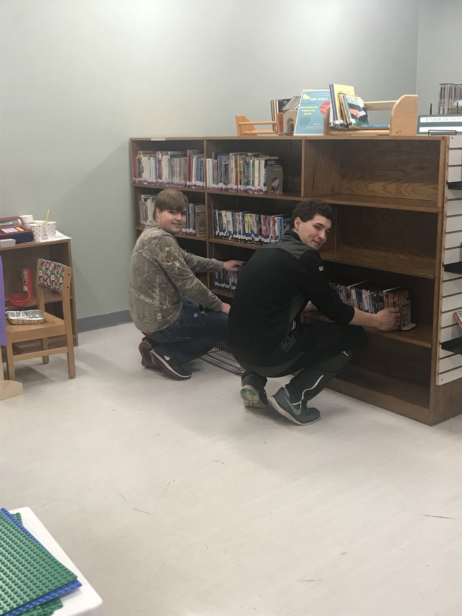 Mason and Doug moving the DVDs at the library!! <a href="/fccrickets/">Fall Creek School District</a> #gocrickets