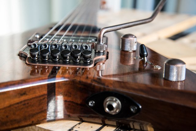 TraqGuitars's tweet photo. "The Druid" #flyingv closeup. Featuring the Schaller low profile floyd in the vintage copper finish that I absolutely love. Goes well with the ovangkol #neckthru and walnut wings. Finished in #truoil #guitar #guitarporn #custom #handmade #traq #traqguitars #guitarbuilding https://t.co/q000OpXp4S