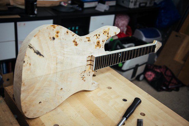 TraqGuitars's tweet photo. On my bench now: just cut the neck pocket in this angled "V-top" basswood body with poplar veneer top. The neck pocket reaches under the pickups, hopefully this will allow the guitar to have a smooth, comfortable heel. #traqguitars #traq #guitar #custom #handmade #guitarbuilding https://t.co/AgMDlksi8r