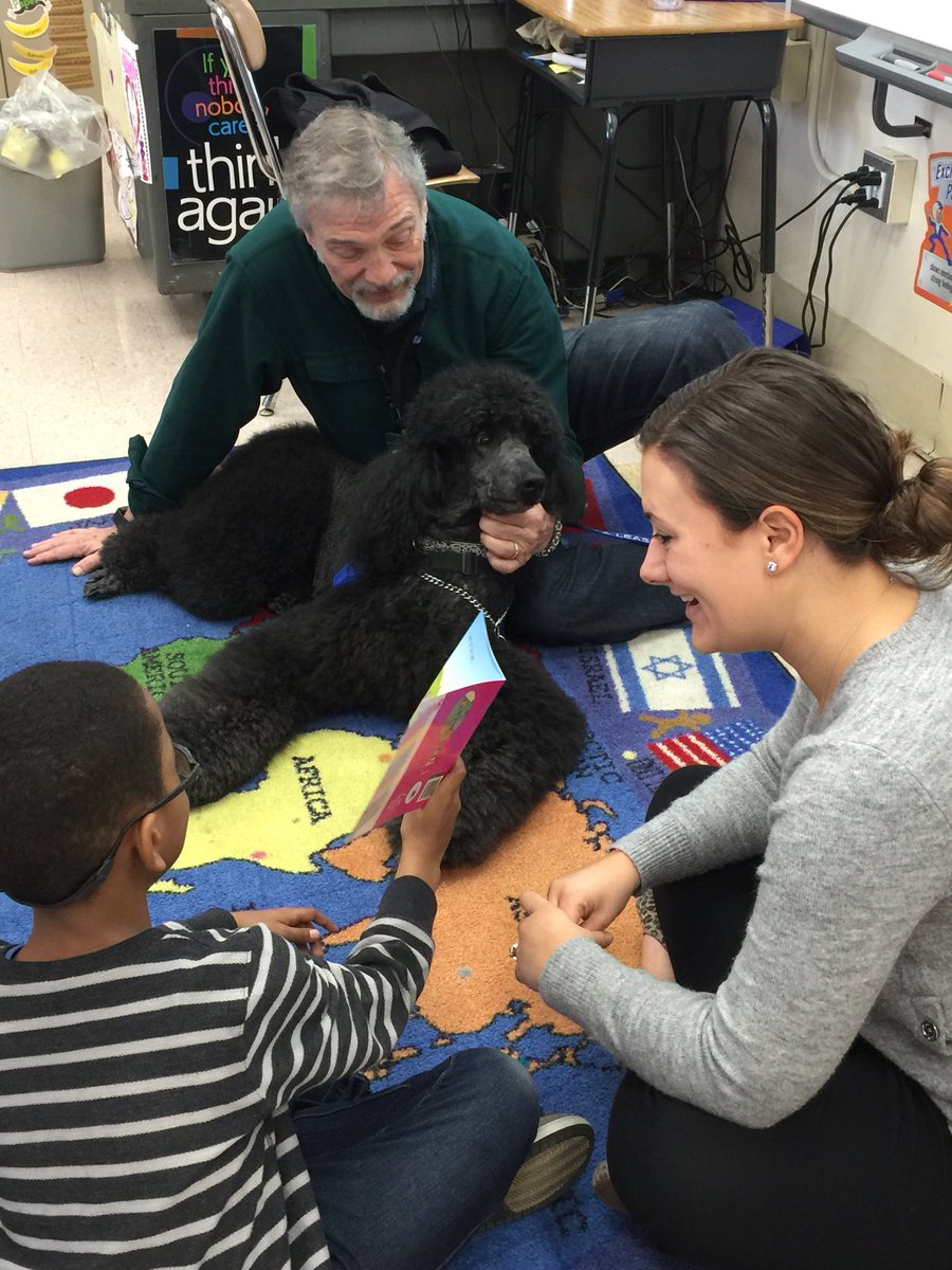 Students read to Cody (the therapy dog) during the PPS pet therapy/reading program